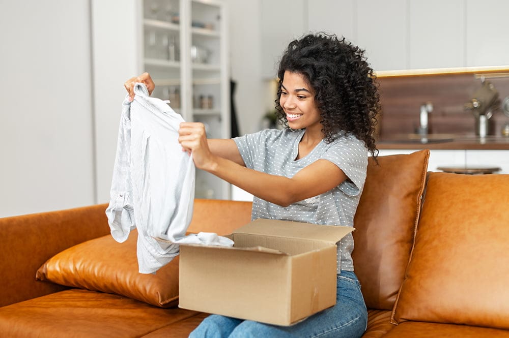 African American woman opening parcel carton box